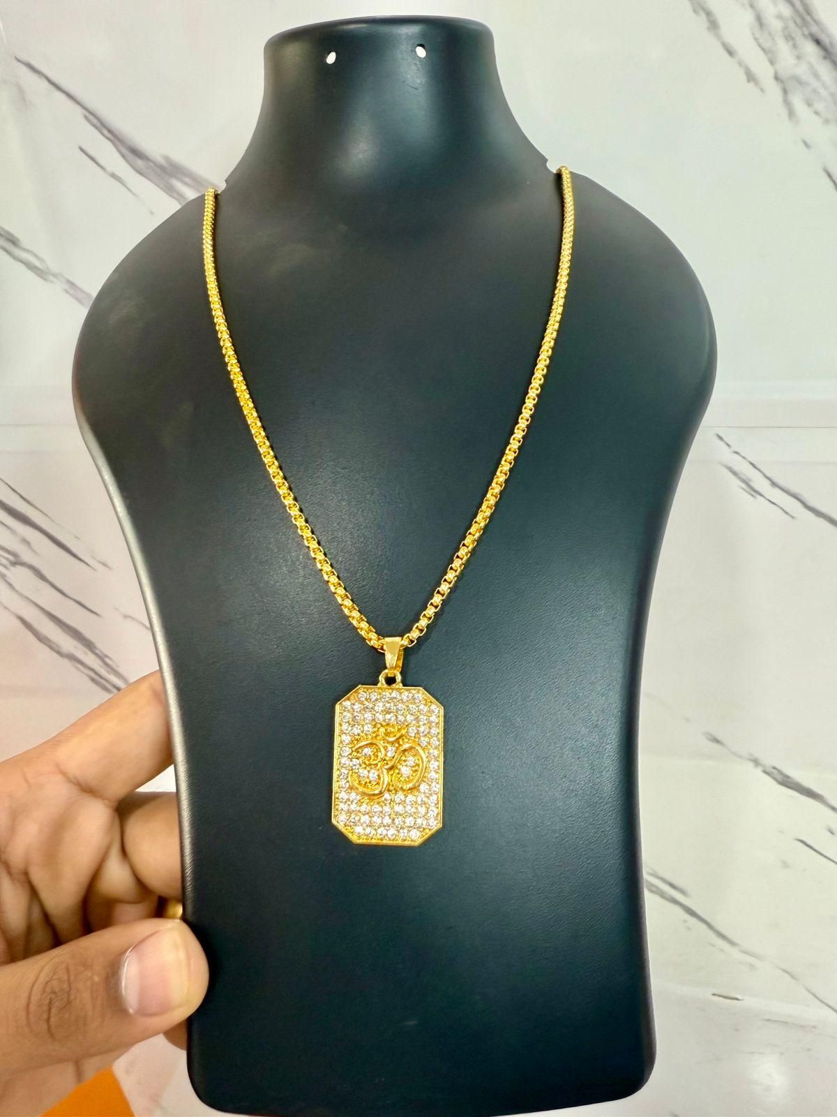 Gold necklace with a pendant on a black mannequin bust against a marble background