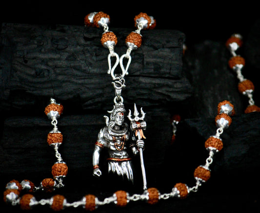 Necklace with pendant featuring a deity figure on a dark background